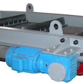 A metal industrial conveyor mechanism, featuring a blue electric motor attached to a gray frame, is designed for transporting items on rollers in manufacturing or processing environments.